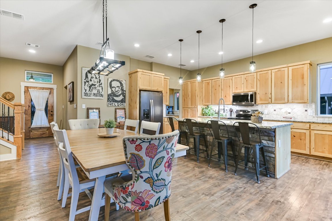 8305 Ozark Drive San Marcos, TX 78666 - Photo 4 of 34 a view of a dining area with furniture window and wooden floor