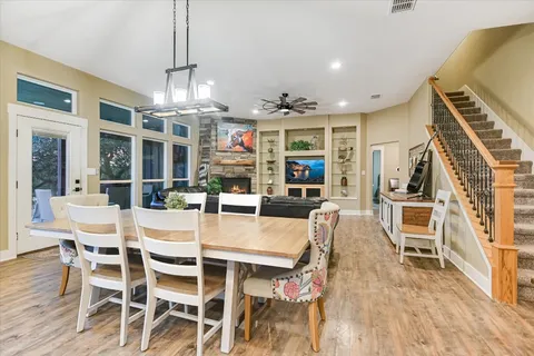 a view of a dining room with furniture a chandelier and wooden floor