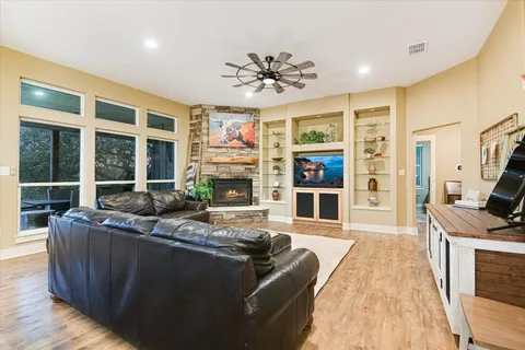 a living room with fireplace furniture and a flat screen tv