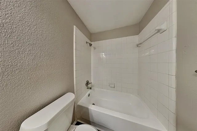a bathroom with a bathtub and toilet