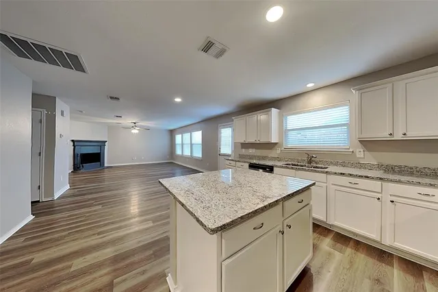 a kitchen with a sink stove and cabinets