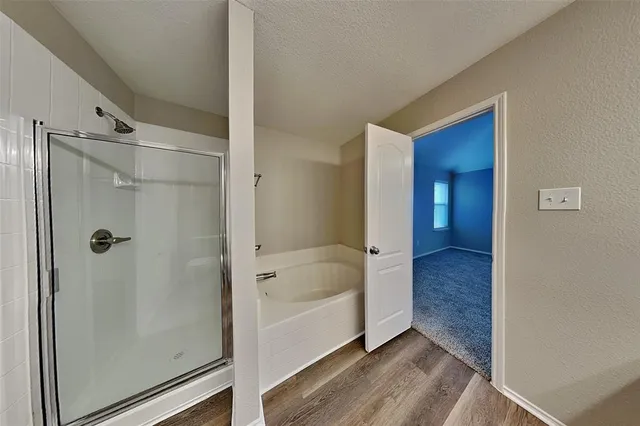 a bathroom with a bathtub and a shower