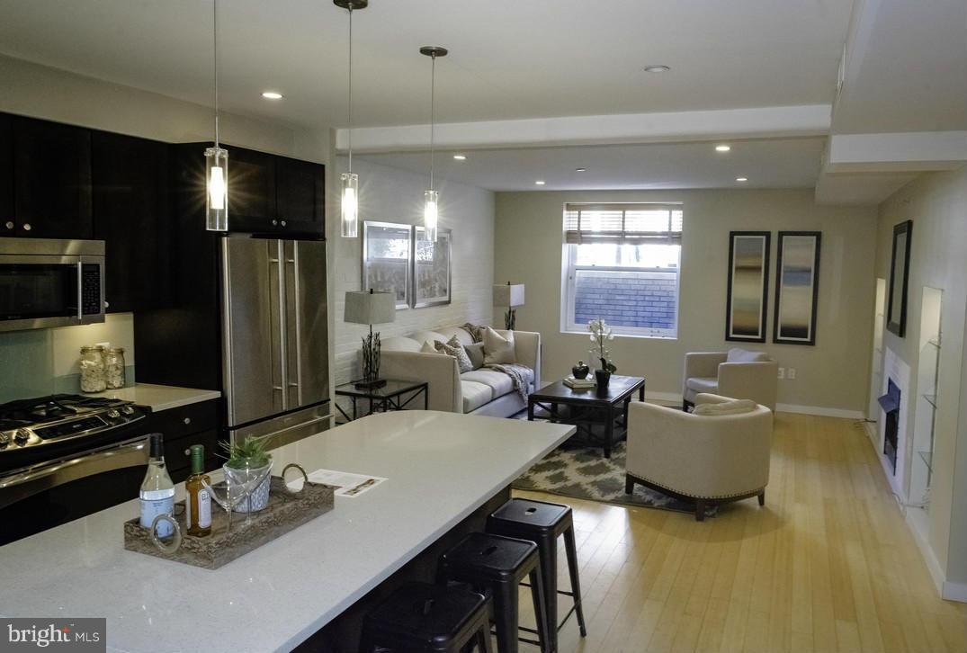 1632 S Street Northwest, Unit 1 Washington, DC 20009 - Photo 2 of 11 a kitchen with a refrigerator and a view of living room