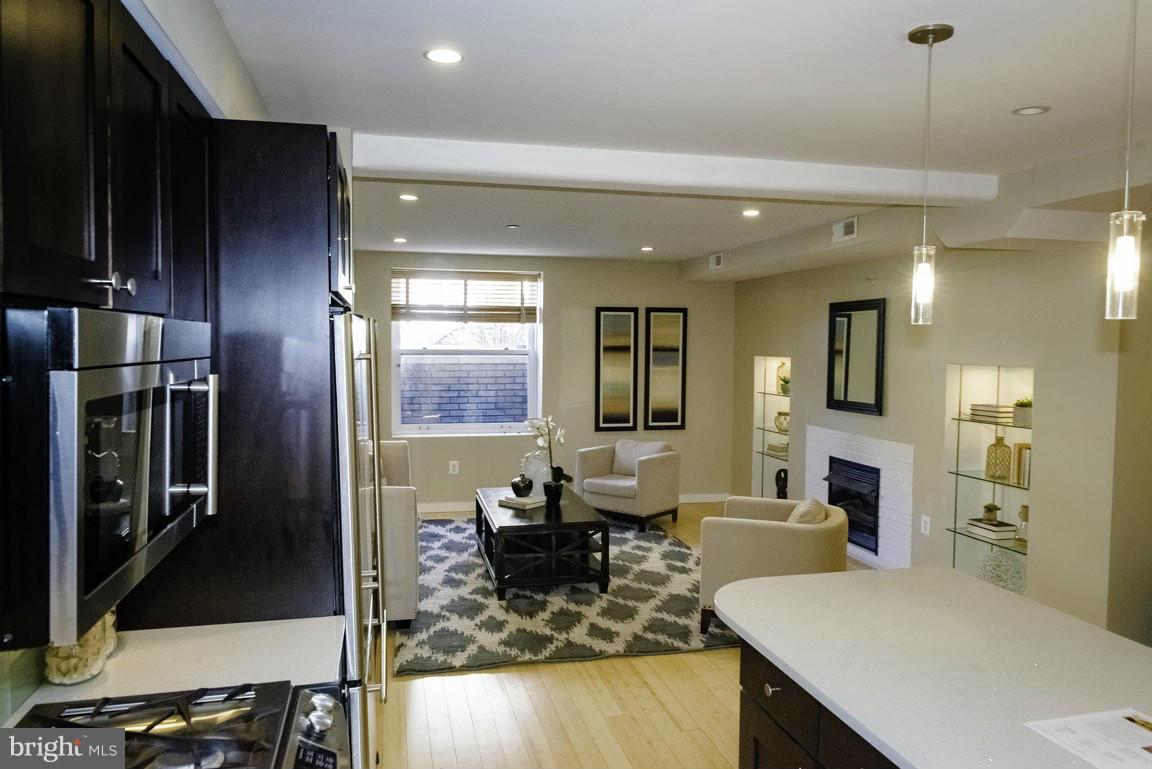 1632 S Street Northwest, Unit 1 Washington, DC 20009 - Photo 4 of 11 a living room with furniture and a fireplace