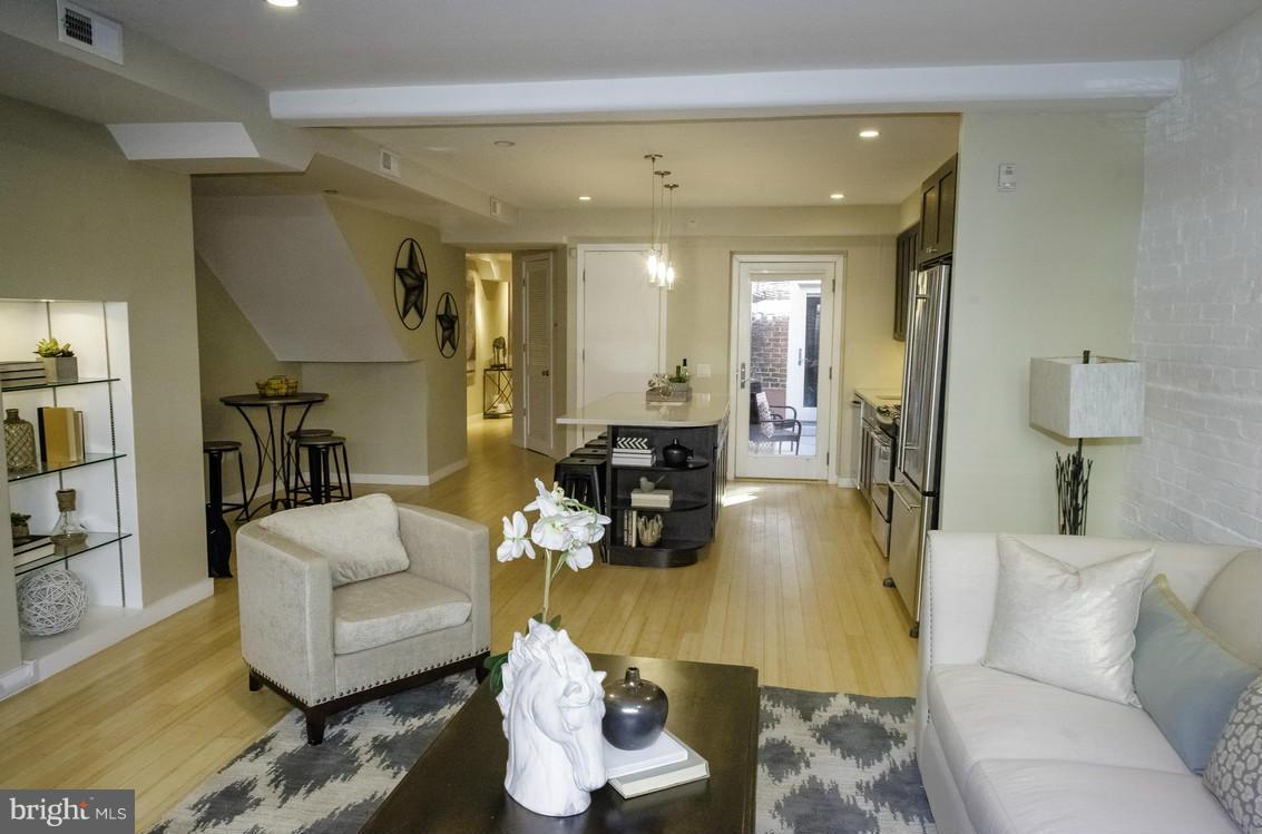 1632 S Street Northwest, Unit 1 Washington, DC 20009 - Photo 5 of 11 a living room with furniture and wooden floor