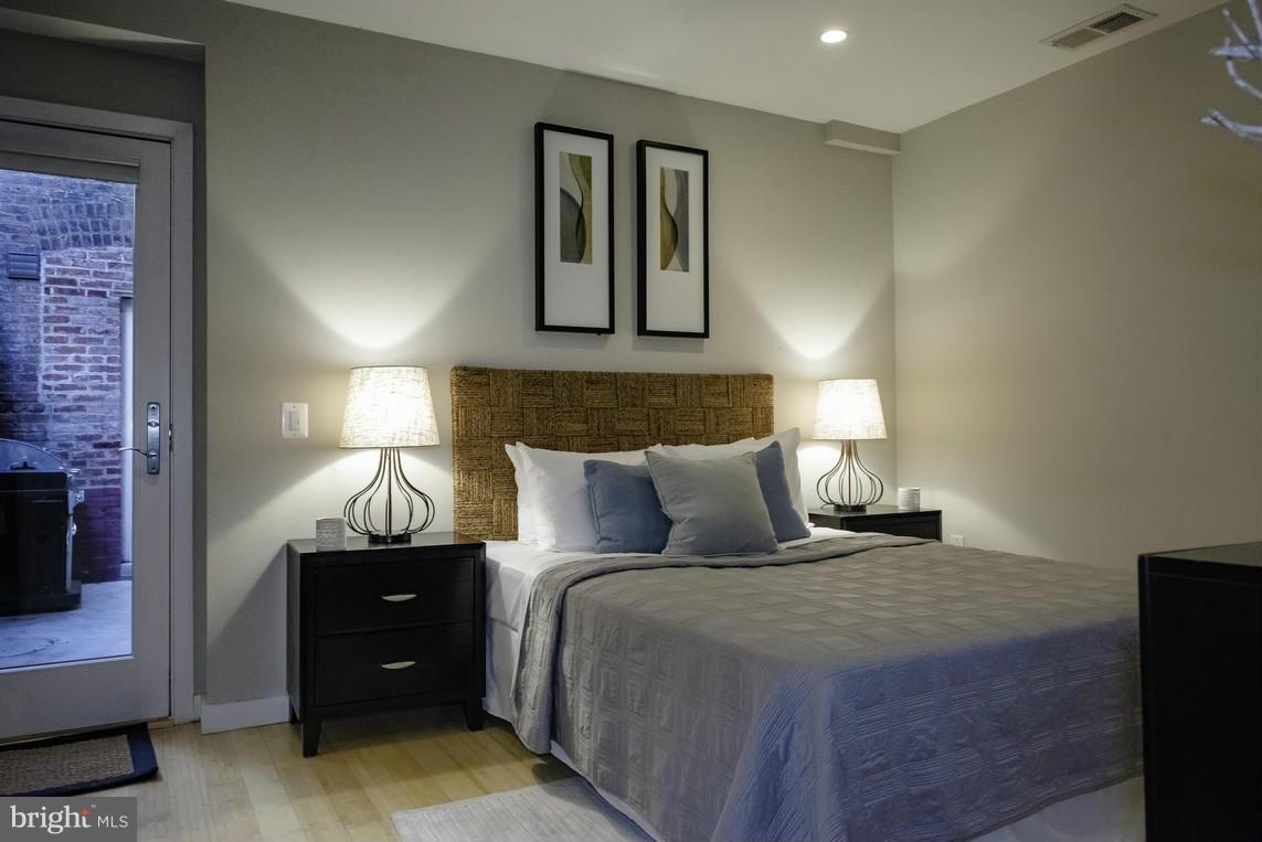 1632 S Street Northwest, Unit 1 Washington, DC 20009 - Photo 6 of 11 a bed room with a bed and a night stand