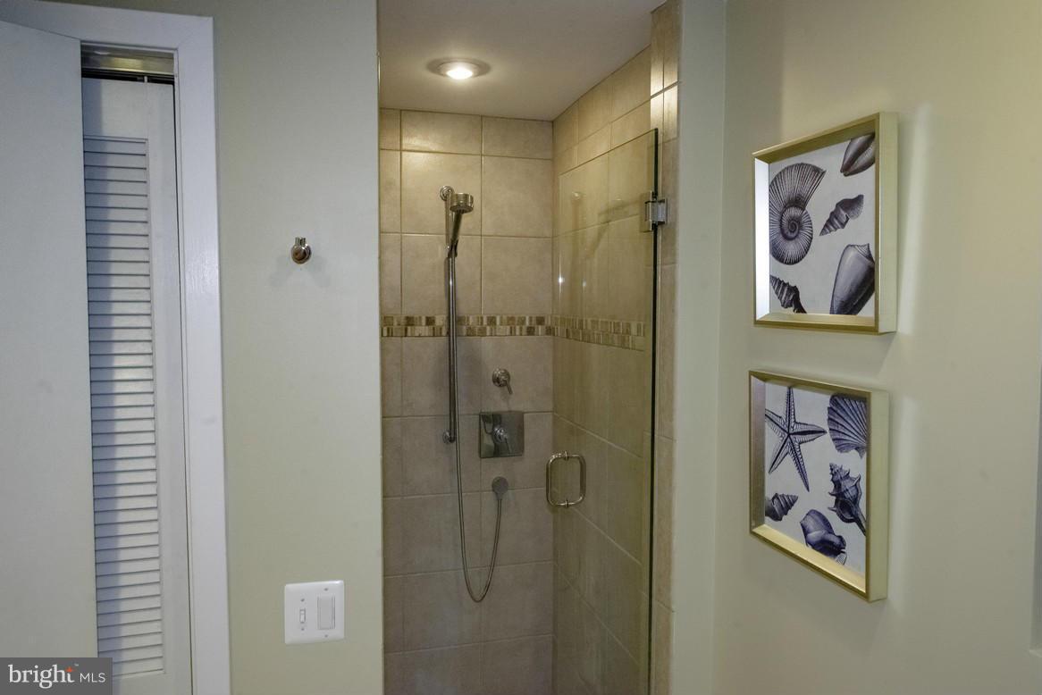 1632 S Street Northwest, Unit 1 Washington, DC 20009 - Photo 9 of 11 a bathroom with a painting on the wall and shower