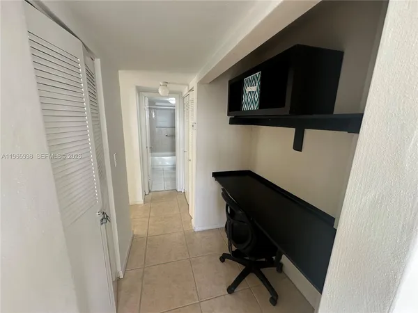 a living room with a chair and a flat screen tv
