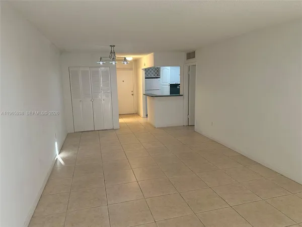 a view of a kitchen with a sink and a refrigerator