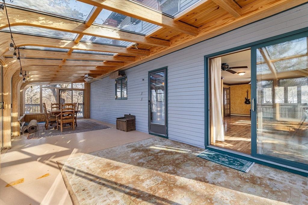 100 Asnebumskit Road Paxton, MA 01612 - Photo 14 of 42 a view of a porch with chairs and couches in patio