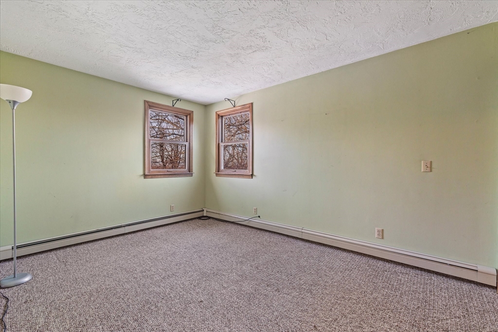 100 Asnebumskit Road Paxton, MA 01612 - Photo 22 of 42 a view of an empty room with a window
