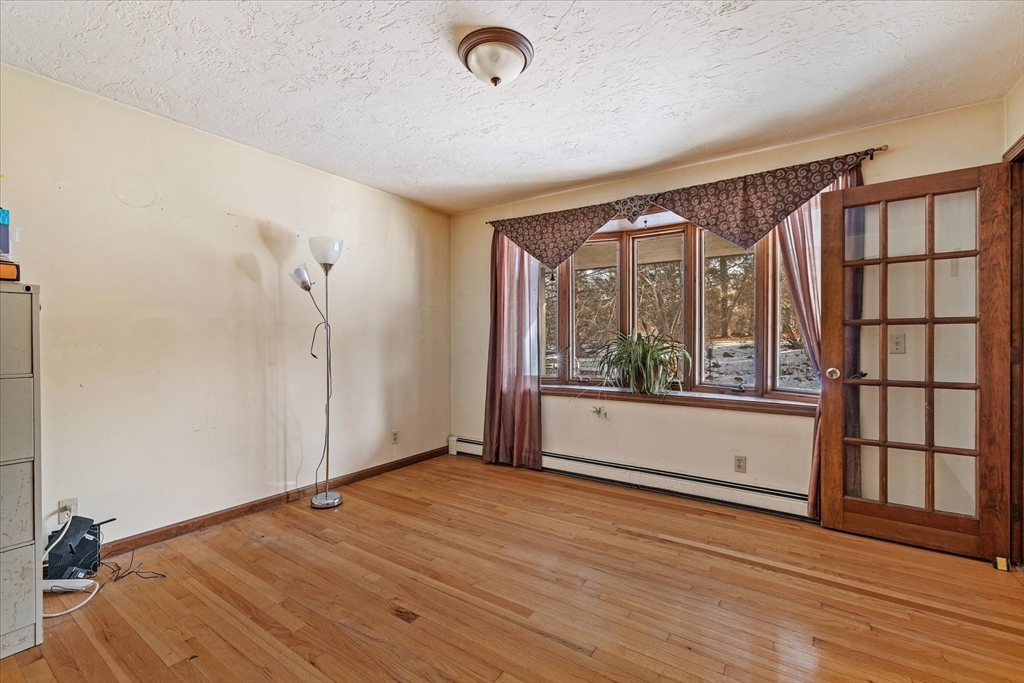 100 Asnebumskit Road Paxton, MA 01612 - Photo 10 of 42 an empty room with wooden floor and windows