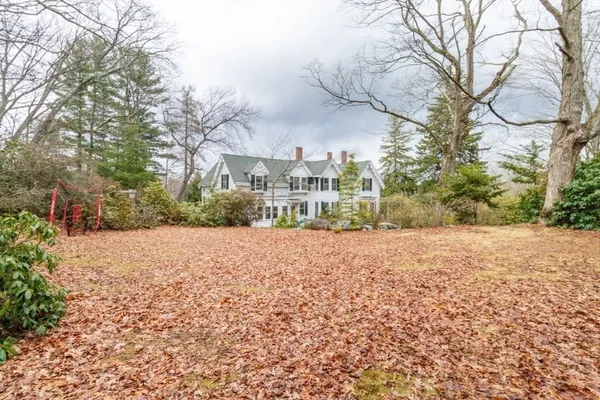 a view of large house with a yard and trees