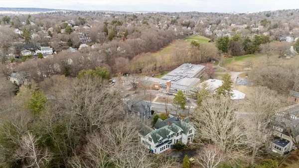 an aerial view of house with yard and mountain view