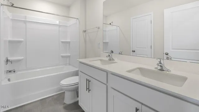 a bathroom with a sink a toilet and a large mirror