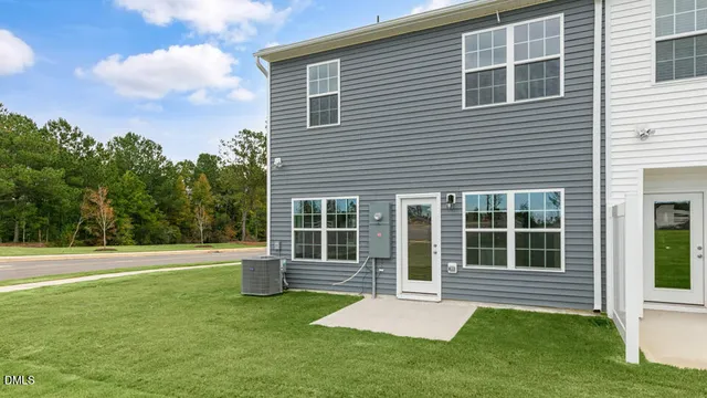a view of green house with a yard and a large window