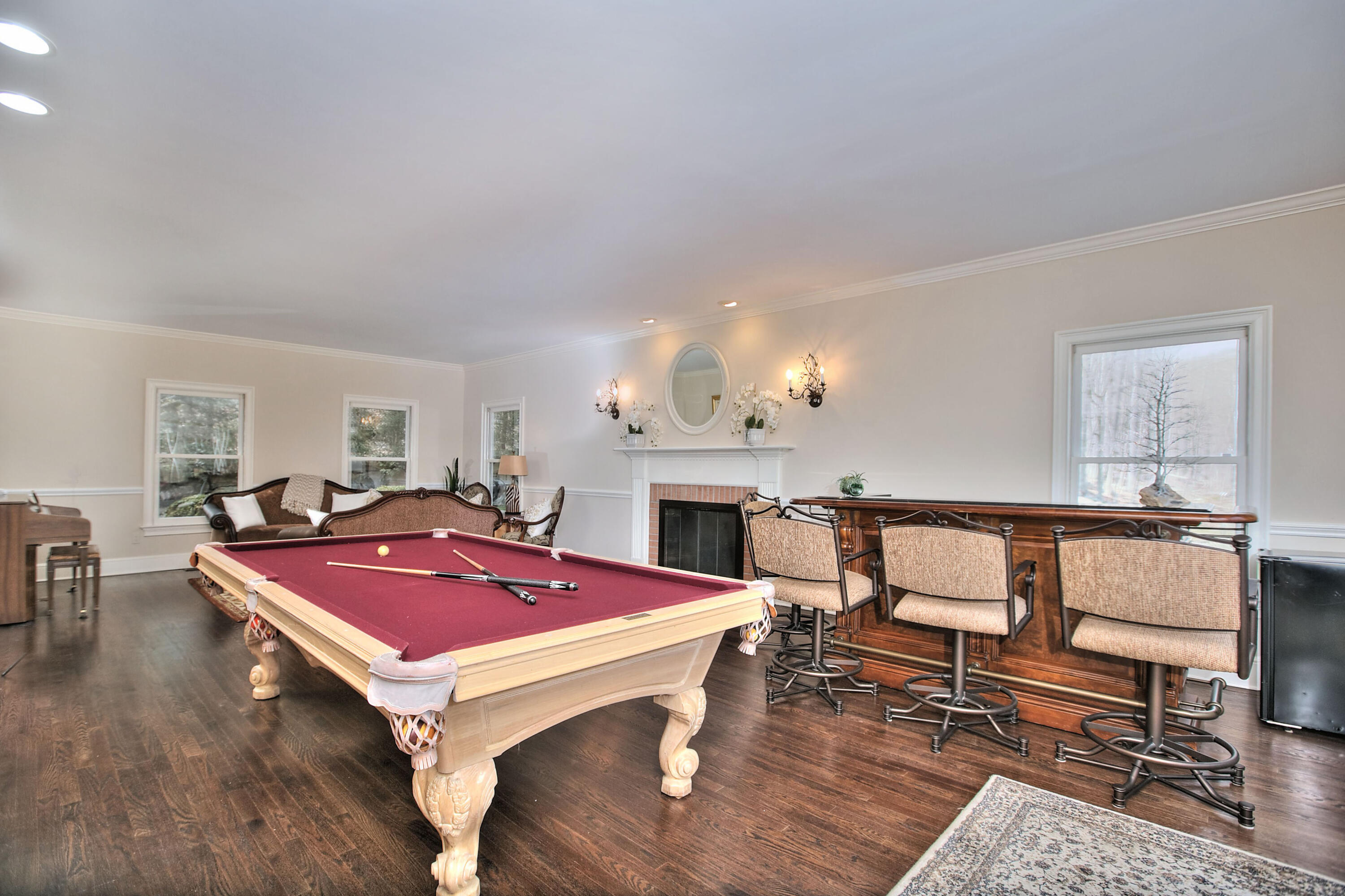 191 Smith Ridge Road New Canaan, CT 06840 - Photo 16 of 42 a living room with furniture a rug and a fireplace