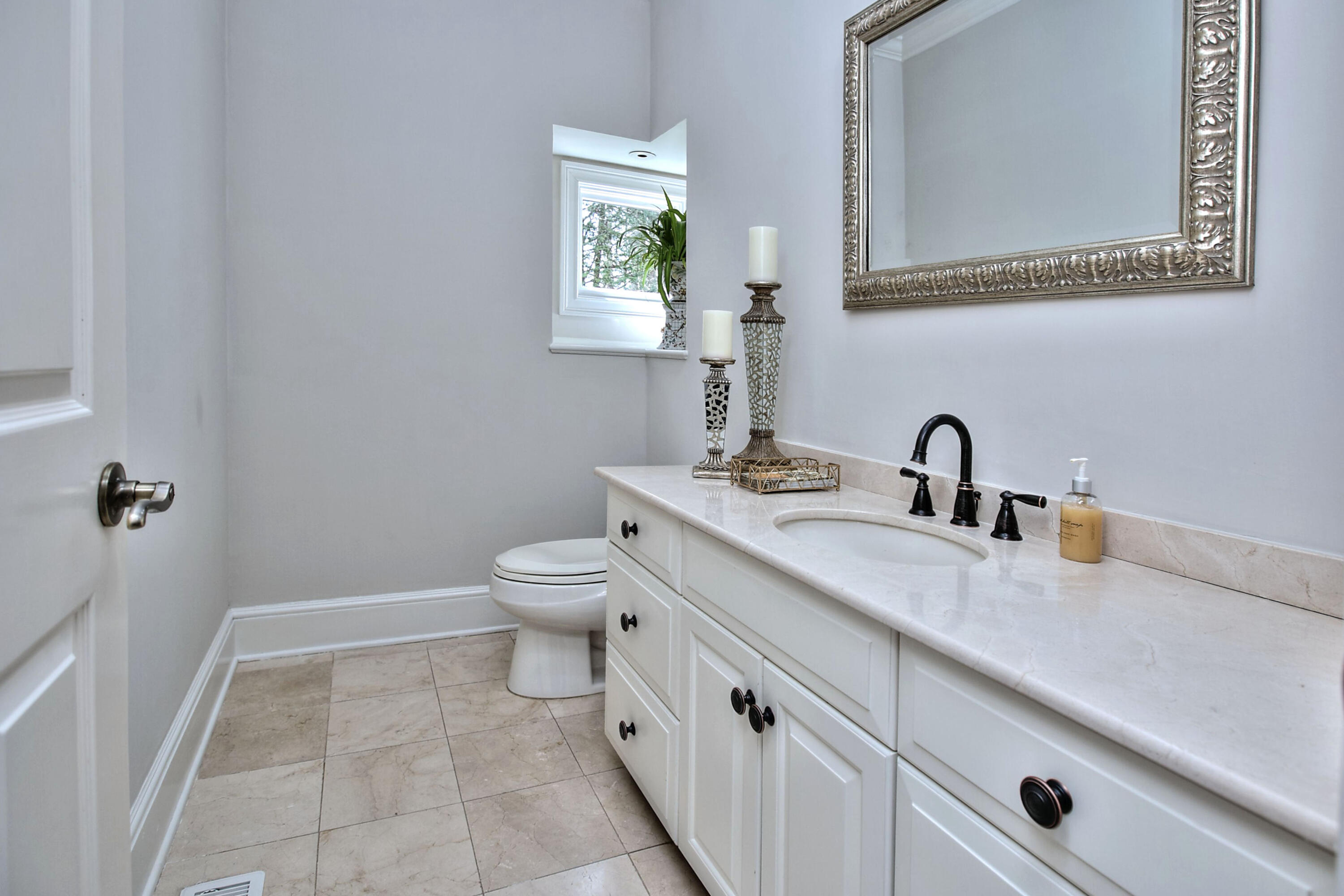 191 Smith Ridge Road New Canaan, CT 06840 - Photo 18 of 42 a bathroom with a toilet sink and mirror