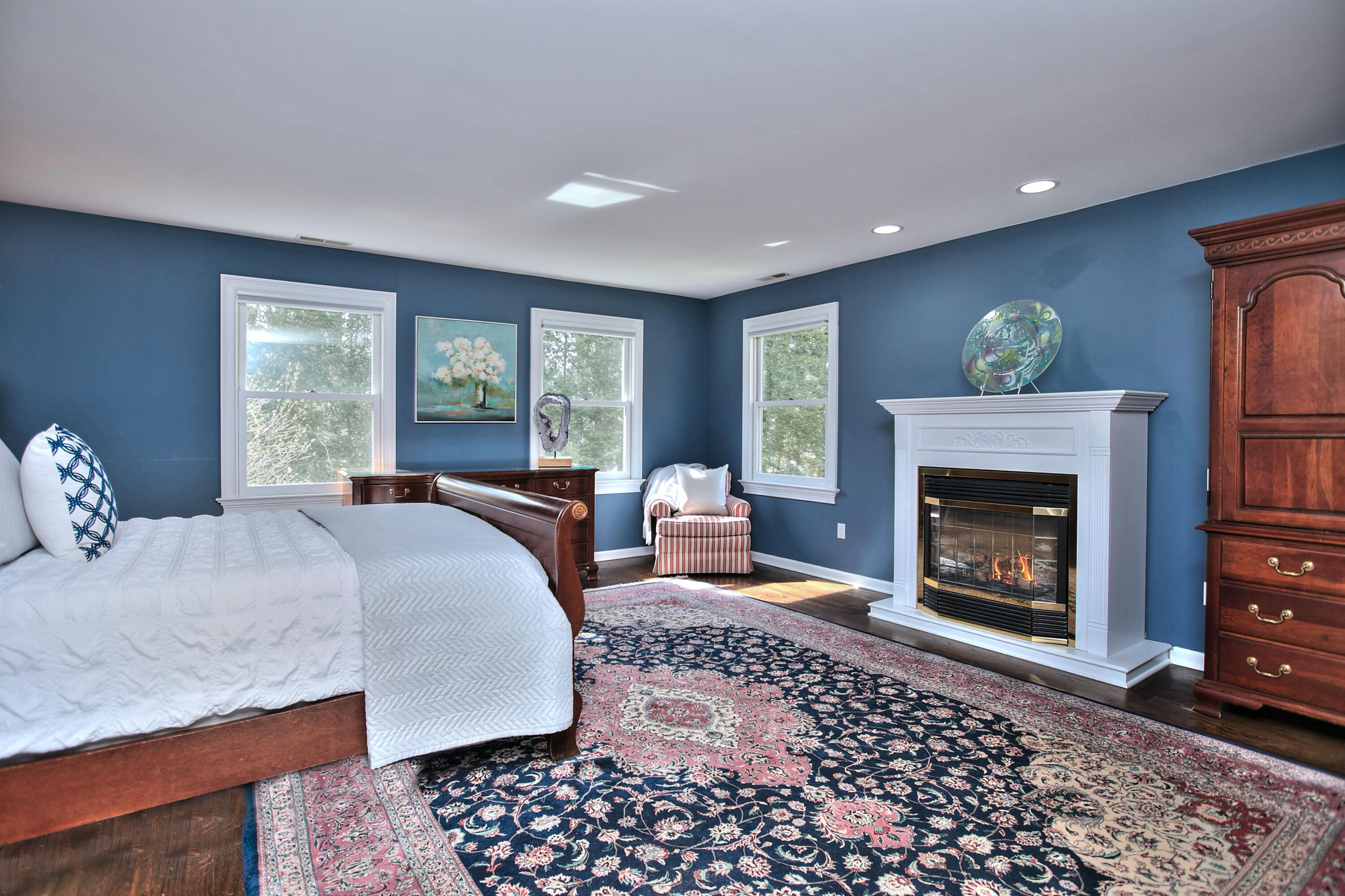 191 Smith Ridge Road New Canaan, CT 06840 - Photo 19 of 42 a bed room with a bed and a fireplace