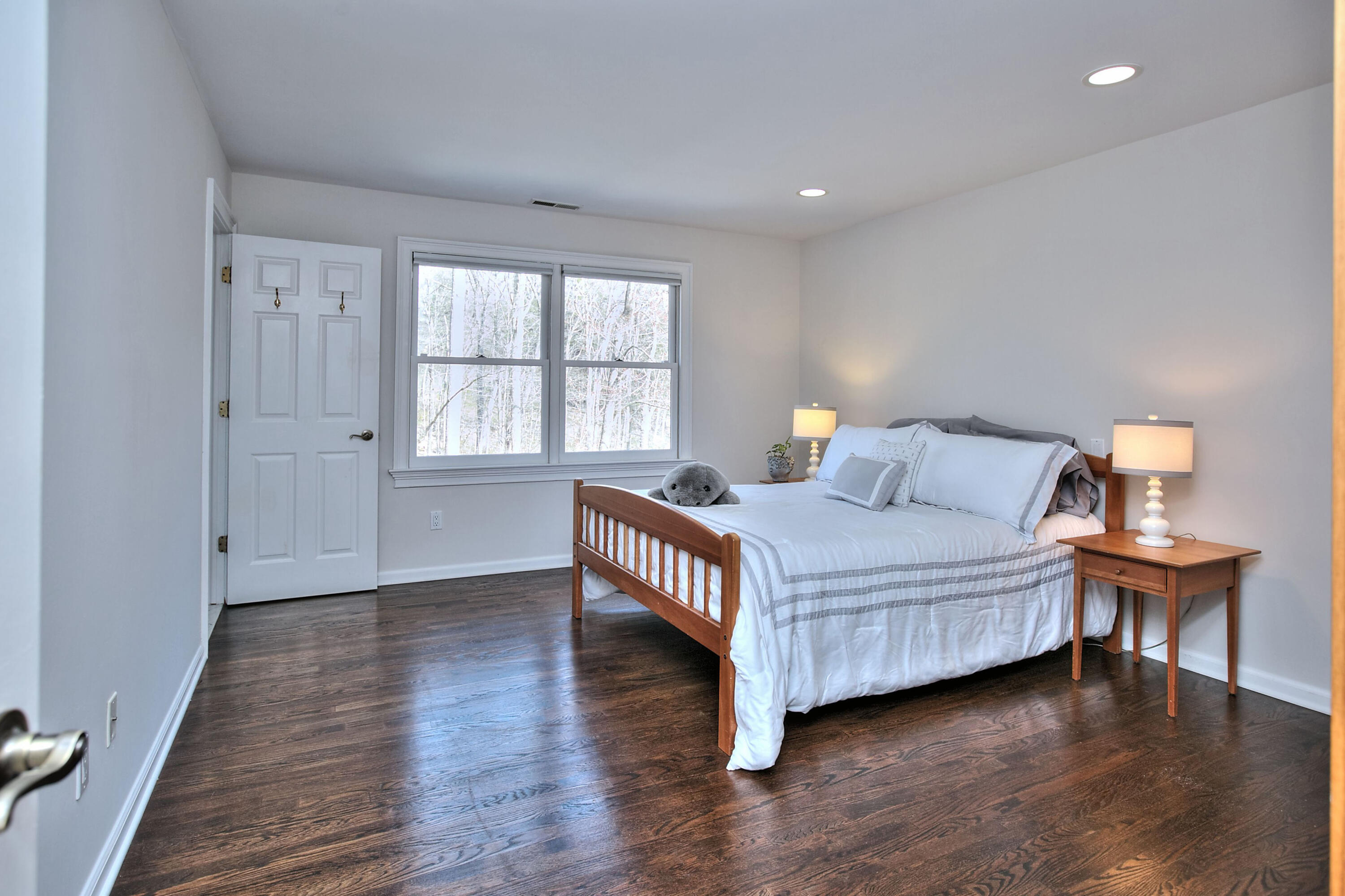 191 Smith Ridge Road New Canaan, CT 06840 - Photo 26 of 42 a bedroom with a bed and wooden floor