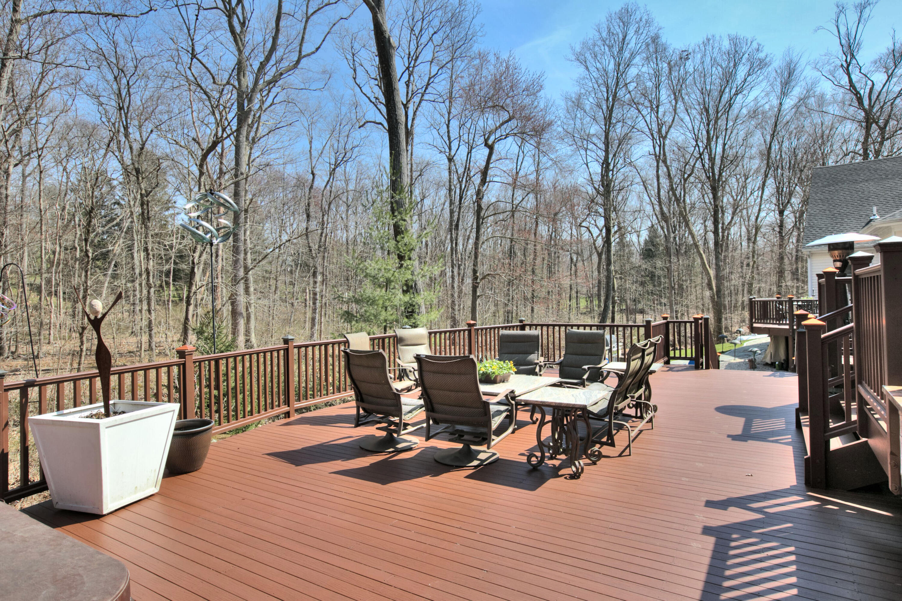 191 Smith Ridge Road New Canaan, CT 06840 - Photo 35 of 42 a view of a patio with dining table and chairs with wooden floor and fence