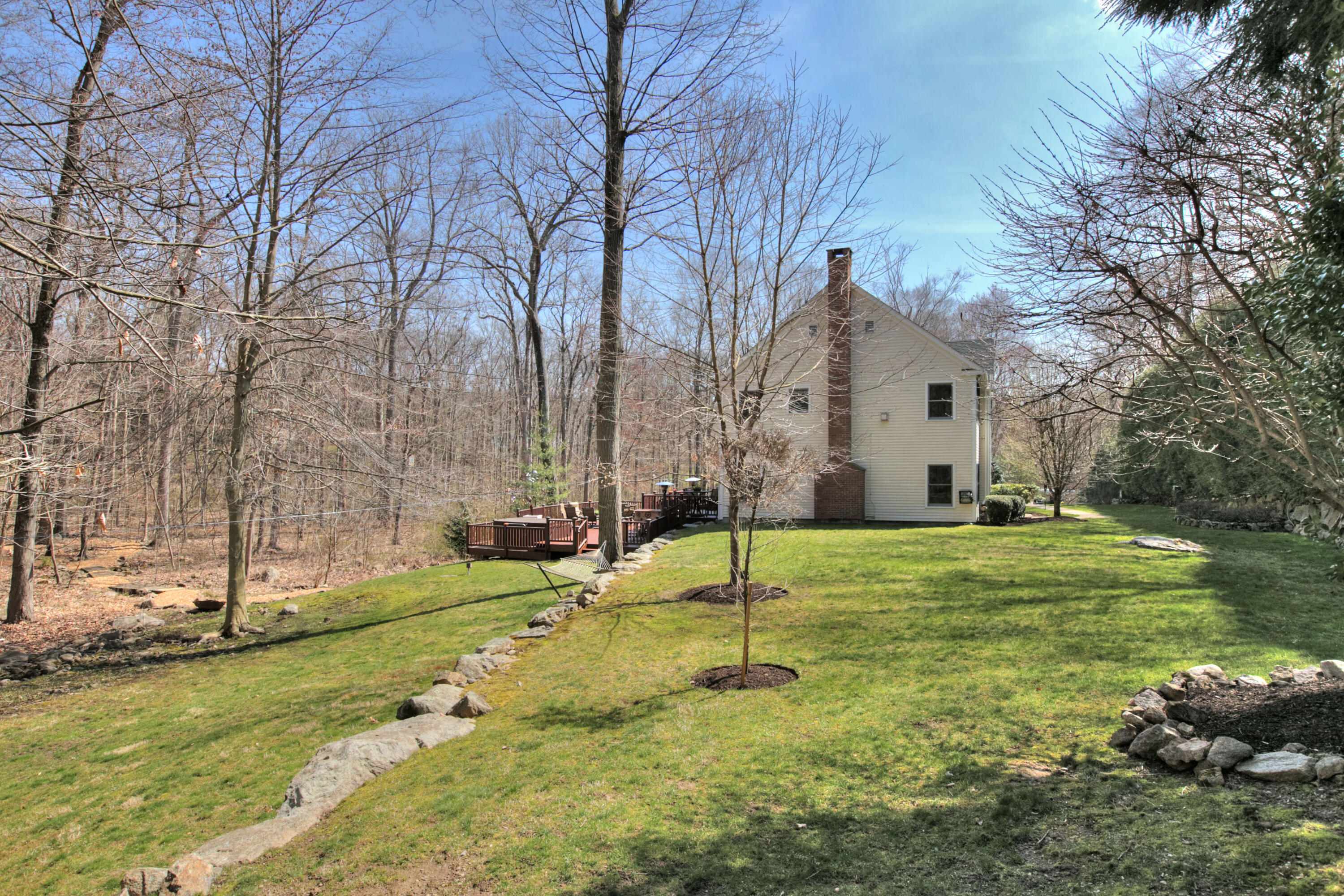 191 Smith Ridge Road New Canaan, CT 06840 - Photo 39 of 42 a backyard of apartments with large trees