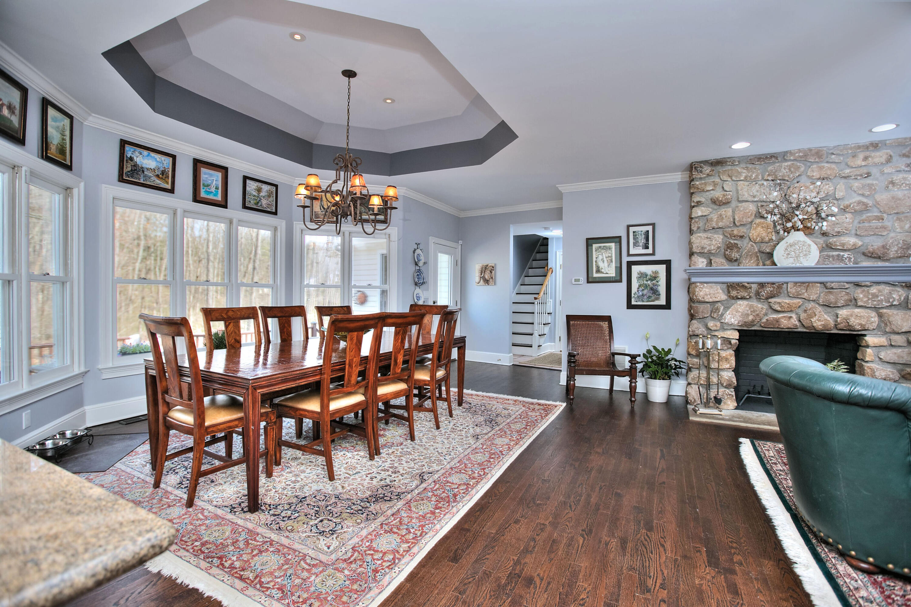 191 Smith Ridge Road New Canaan, CT 06840 - Photo 10 of 42 a dining room with furniture a chandelier and wooden floor