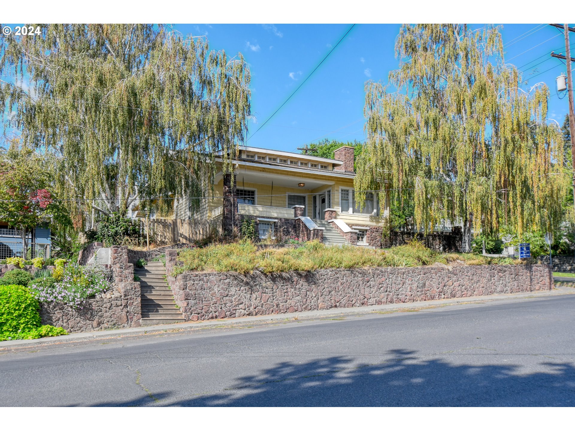 421 North Main Street Pendleton, OR 97801 - Photo 1 of 48 a front view of a house with a yard and potted plants