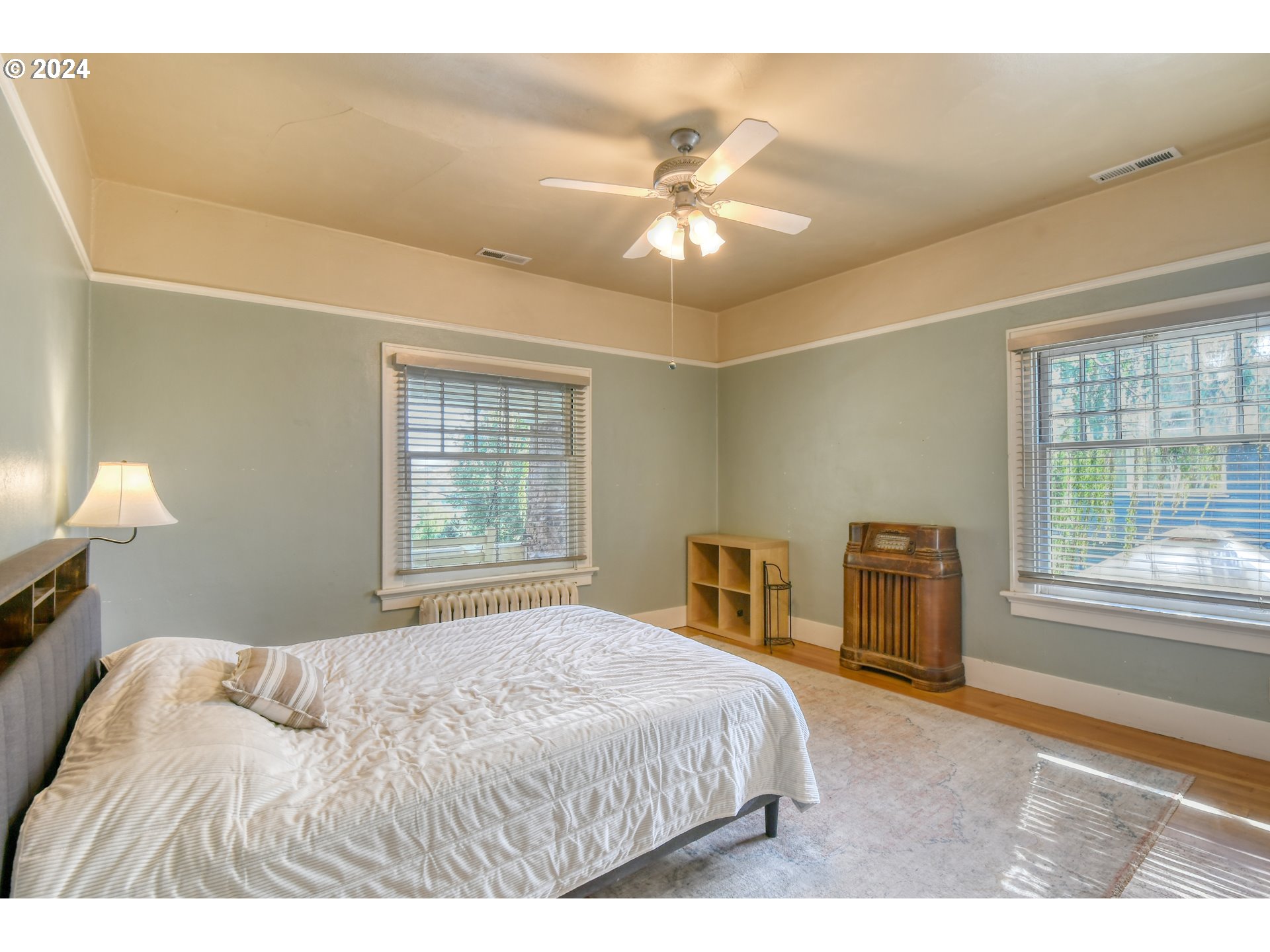 421 North Main Street Pendleton, OR 97801 - Photo 18 of 48 a bedroom with a bed and a chandelier