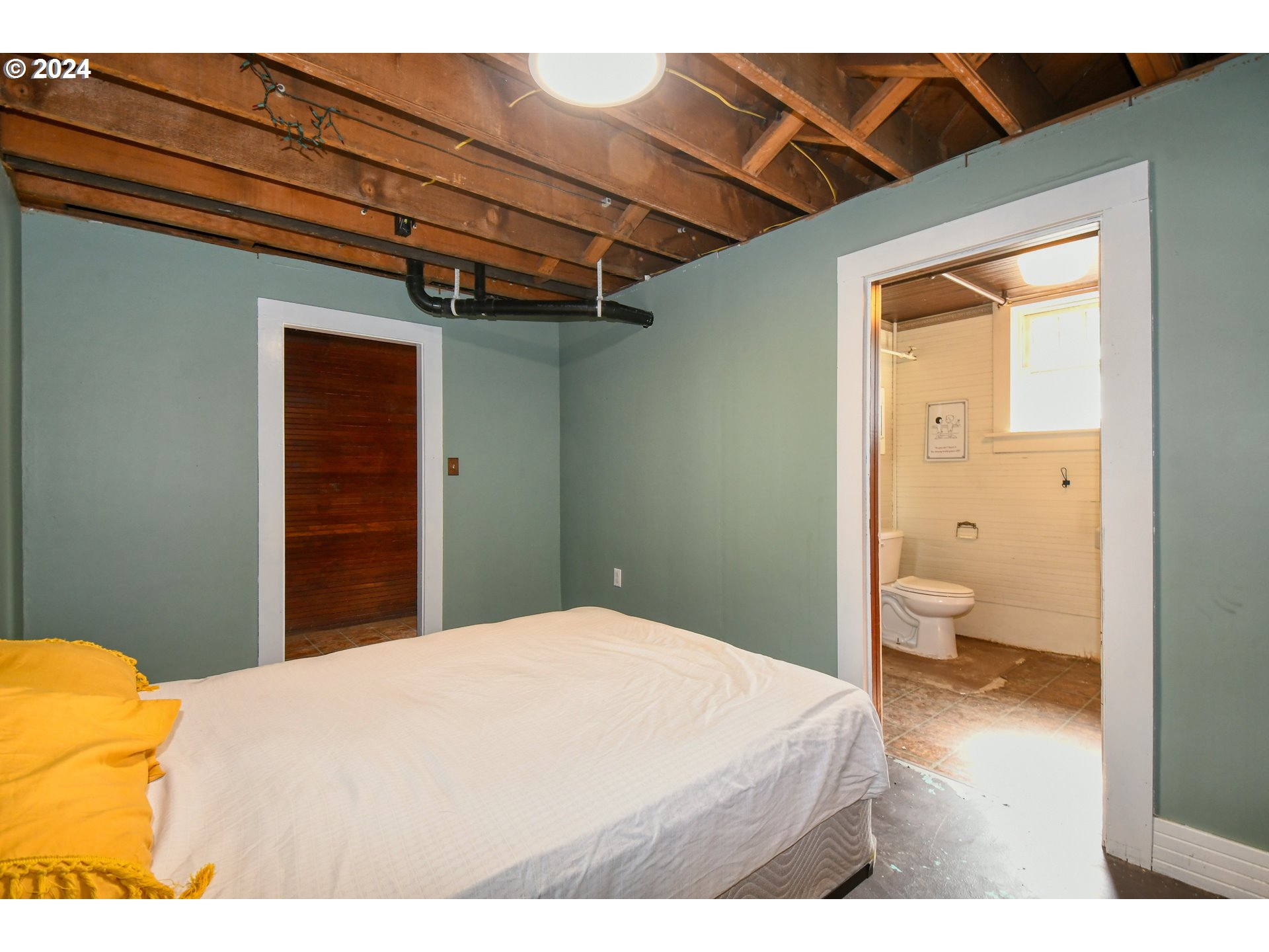 421 North Main Street Pendleton, OR 97801 - Photo 33 of 48 a bedroom with a bed and a chandelier