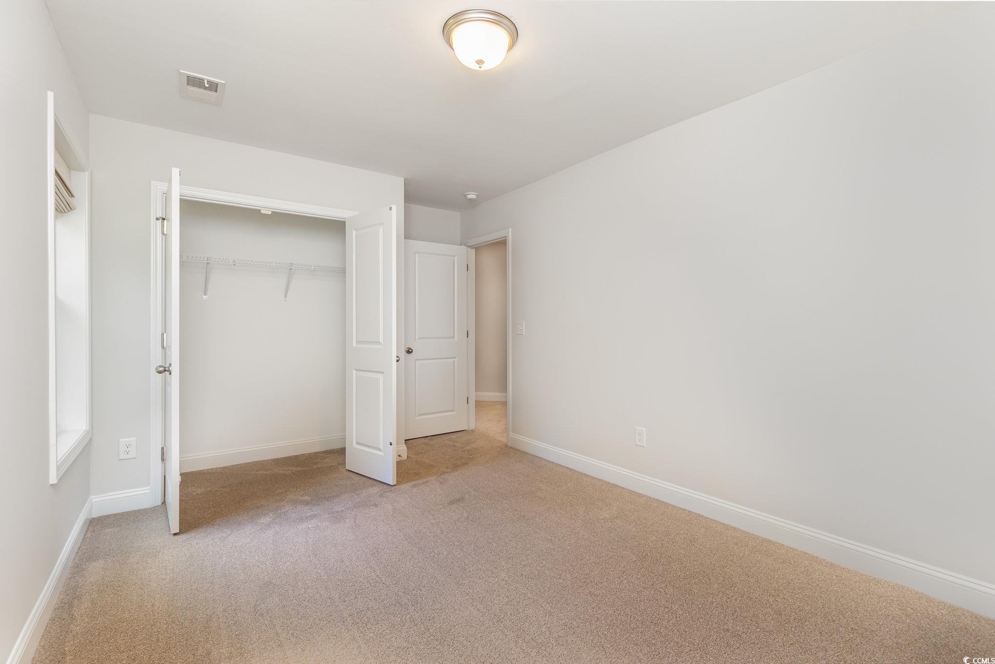 1438 Perch Place Longs, SC 29568 - Photo 22 of 39 Unfurnished bedroom with a closet and carpet floor