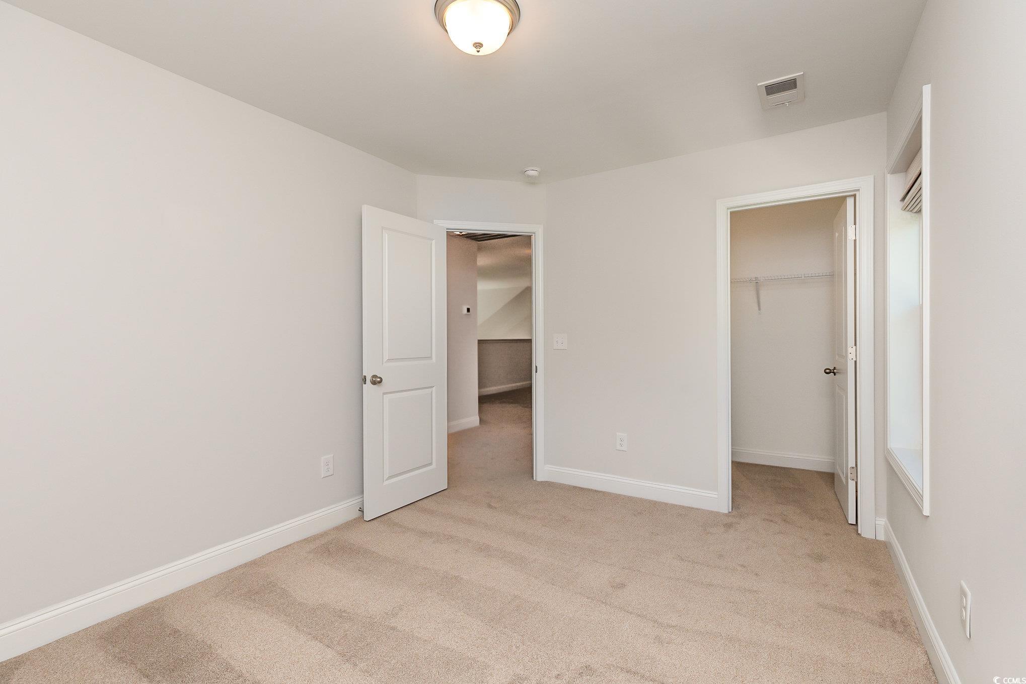 1438 Perch Place Longs, SC 29568 - Photo 28 of 39 Unfurnished bedroom featuring light carpet, a clos