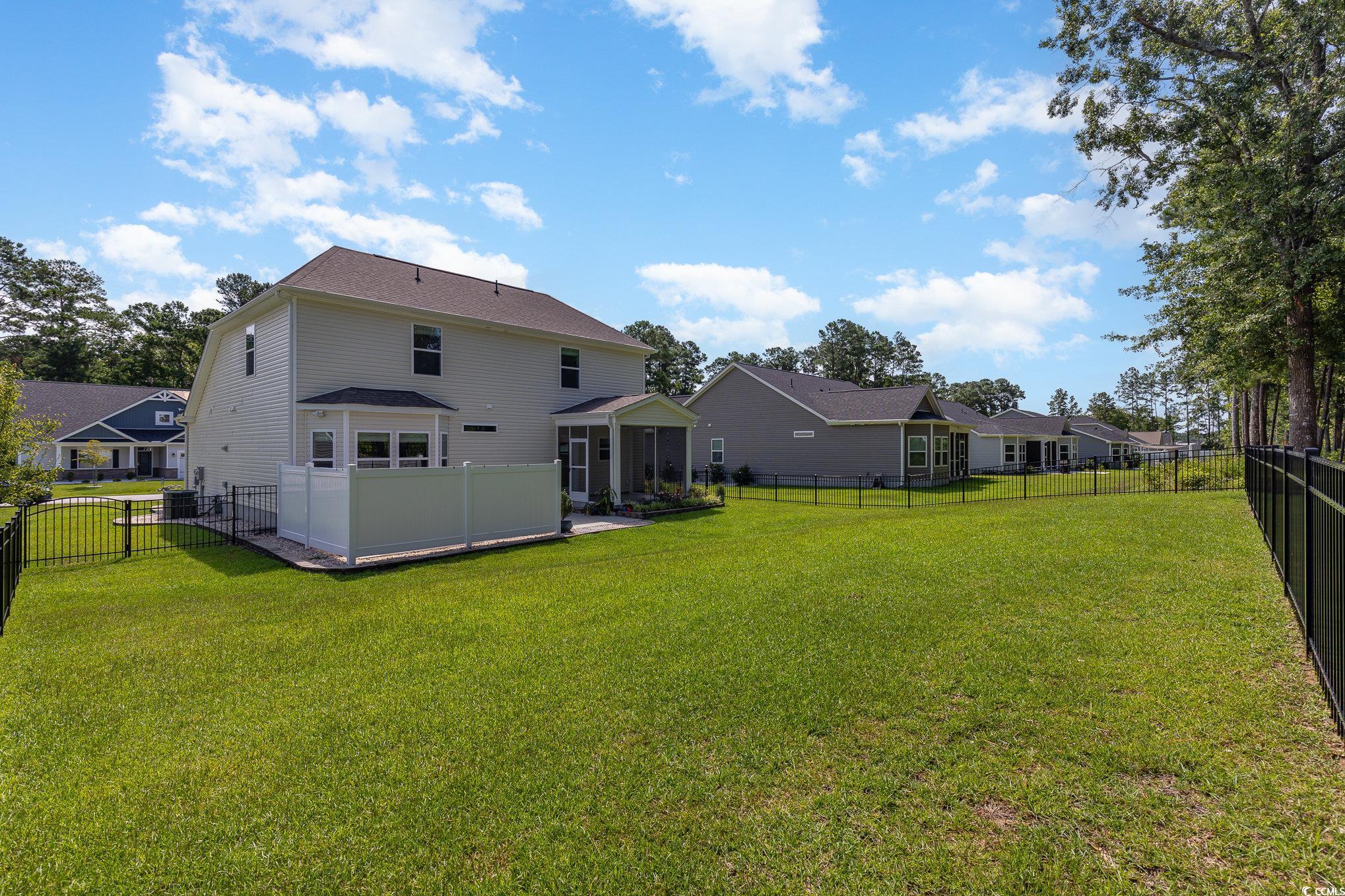 1438 Perch Place Longs, SC 29568 - Photo 33 of 39 Back of house featuring a lawn