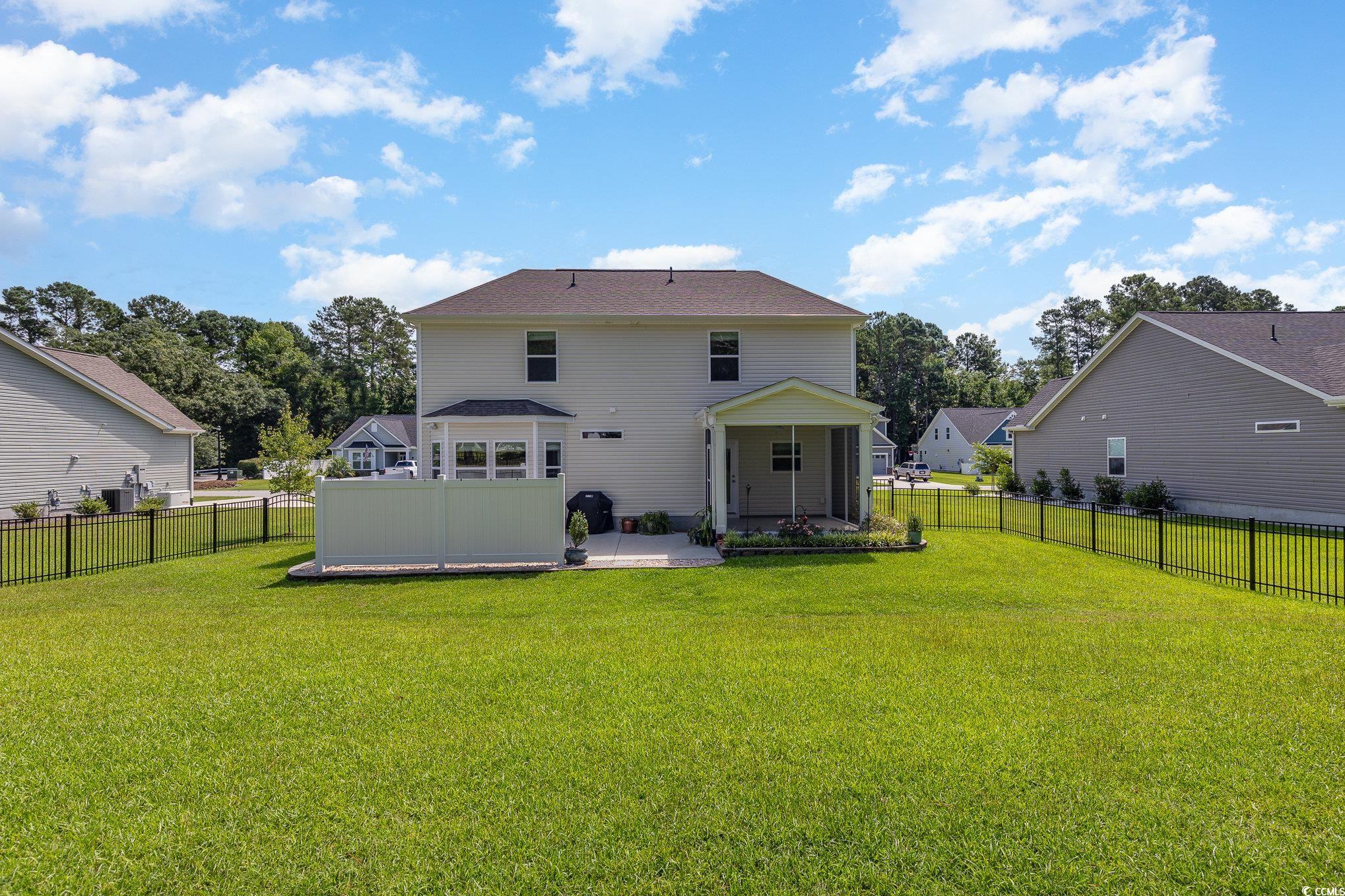 1438 Perch Place Longs, SC 29568 - Photo 34 of 39 Back of house featuring a patio and a lawn