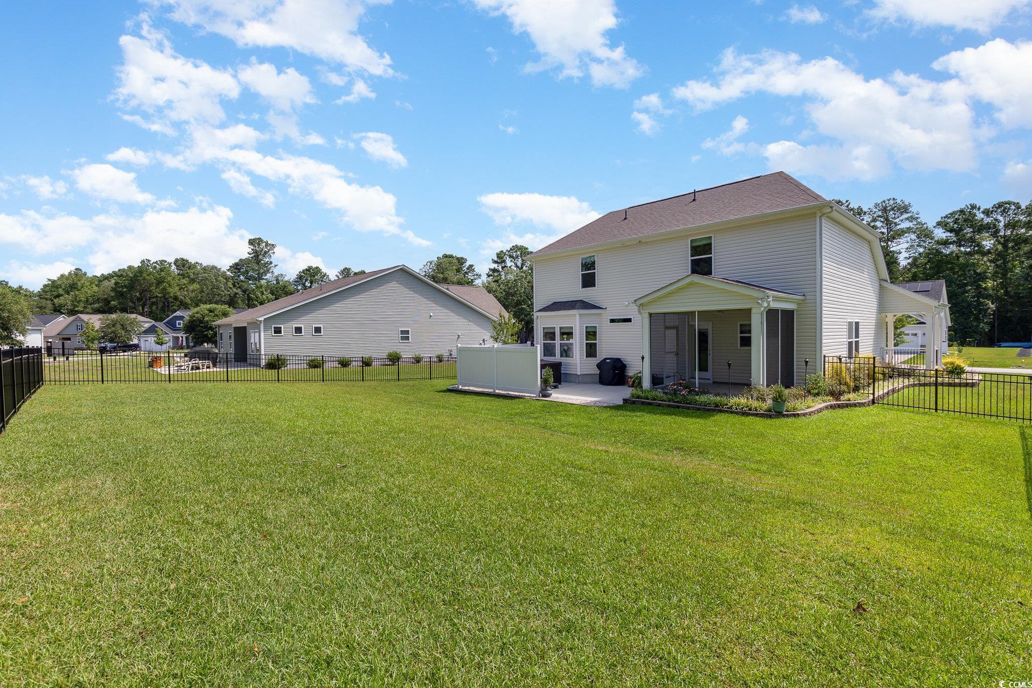 1438 Perch Place Longs, SC 29568 - Photo 35 of 39 Back of house with a yard and a patio area