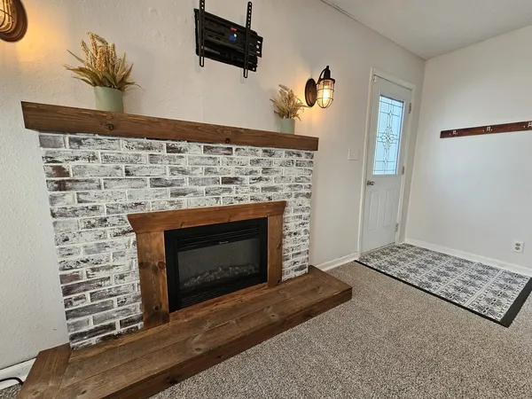 a bathroom with a fireplace and a rug