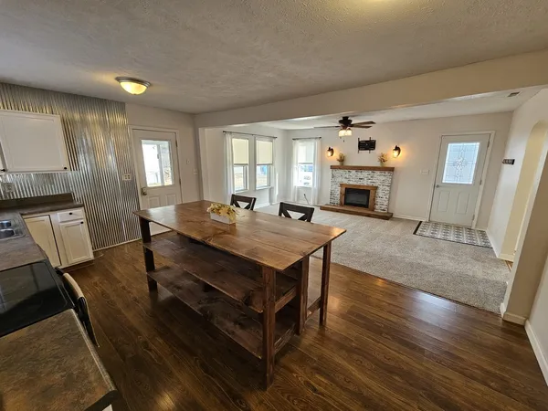 a living room with a table chairs and a fireplace