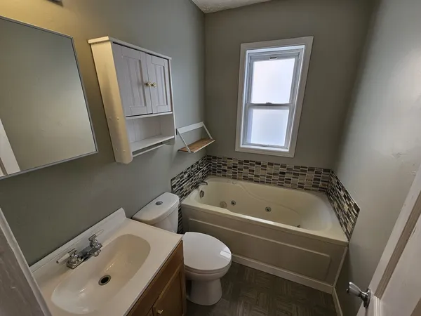 a bathroom with a sink a toilet and a bathtub