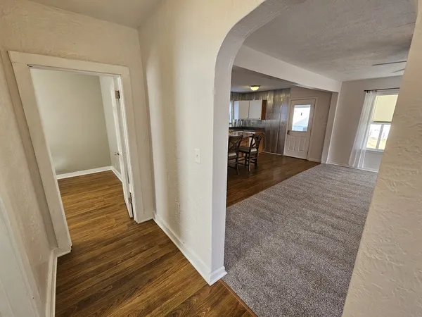 a view of a hallway view with wooden floor and furniture