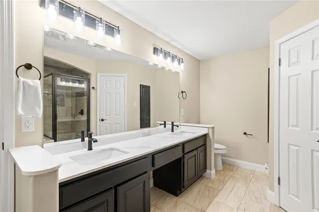 a bathroom with a sink double vanity and a mirror