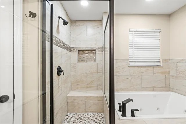a bathroom with a bathtub and a shower