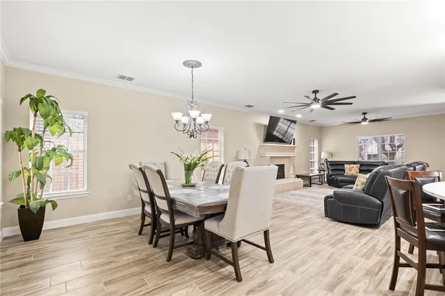 a view of a dining room with furniture wooden floor and chandelier