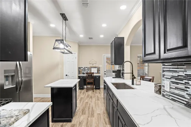 a large kitchen with a large counter top appliances and cabinets