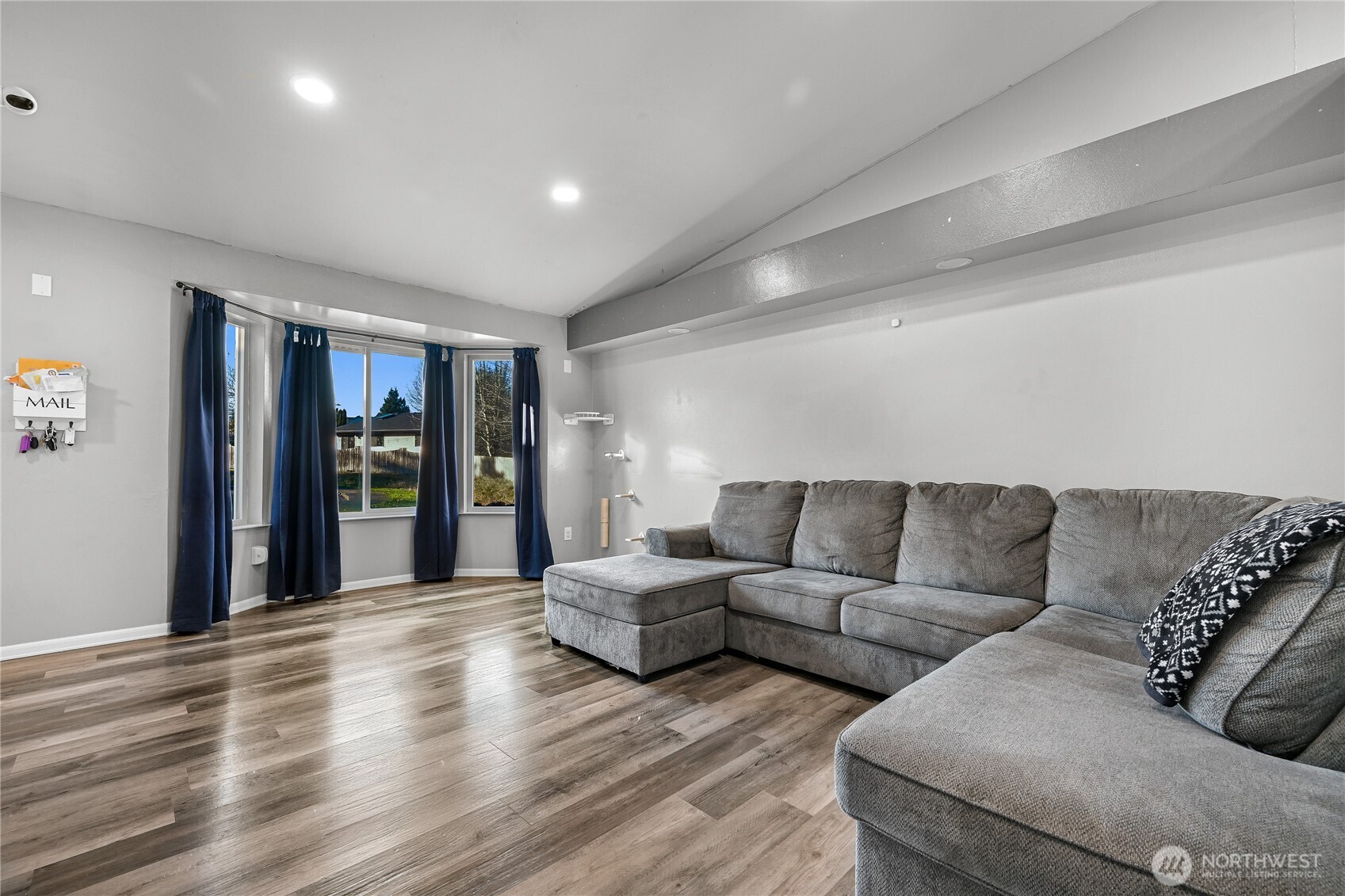 6196 Quail Court Ferndale, WA 98248 - Photo 6 of 27 a living room with couches and kitchen view with wooden floor