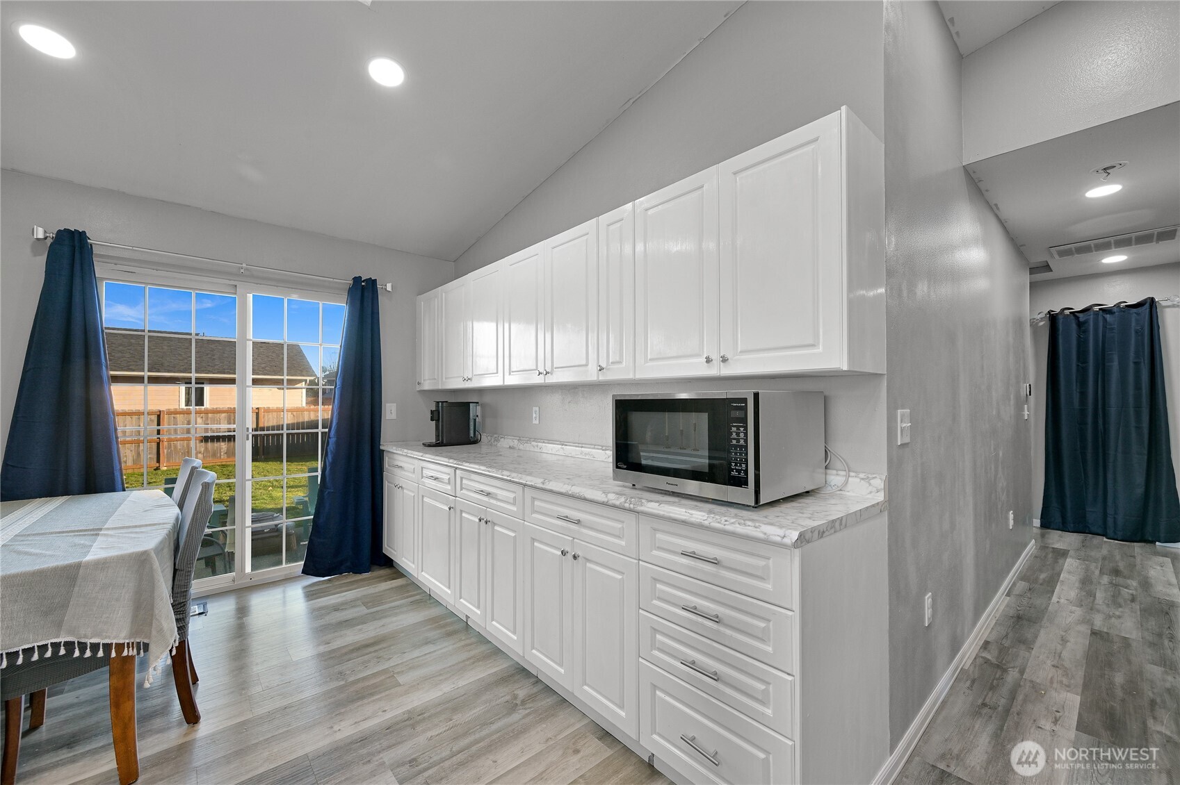 6196 Quail Court Ferndale, WA 98248 - Photo 10 of 27 a kitchen with stainless steel appliances kitchen island granite countertop a stove a sink and a microwave