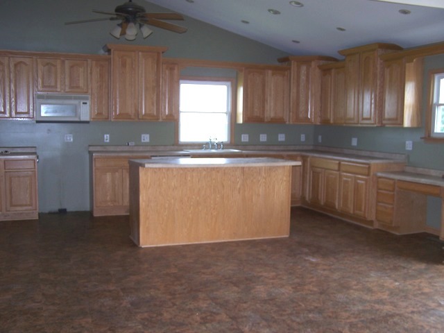 1120 North 32nd Road Ottawa, IL 61350 - Photo 6 of 23 a kitchen with stainless steel appliances granite countertop a stove a sink and a microwave