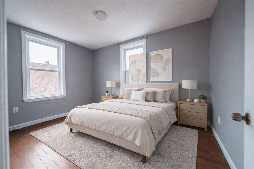 37 Maverick Street Chelsea, MA 02150 - Photo 14 of 25 a bedroom with a bed and window