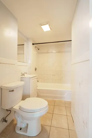 a bathroom with a toilet a sink and a shower