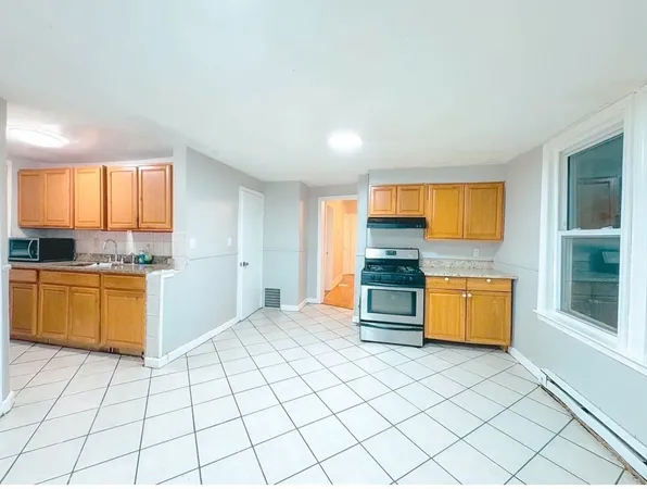 a kitchen with stainless steel appliances a stove a sink and a refrigerator