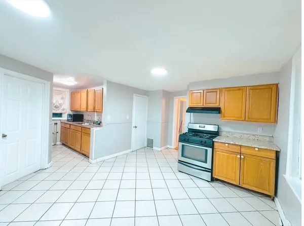 a kitchen with stainless steel appliances a stove top oven and cabinets